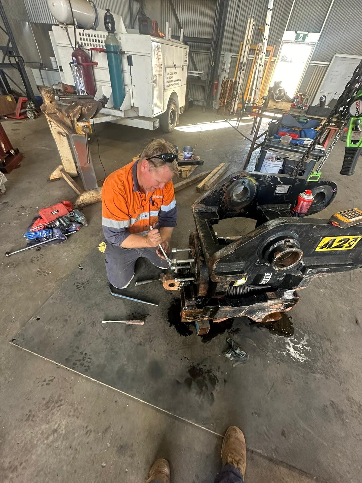Walton Mechanical heavy diesel mechanic working on an excavator attachment