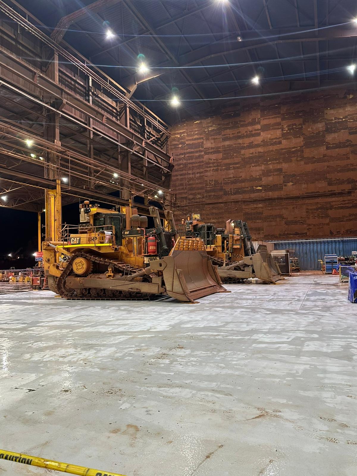 CAT dozers parked under a stockpile shelter on a WA mine site