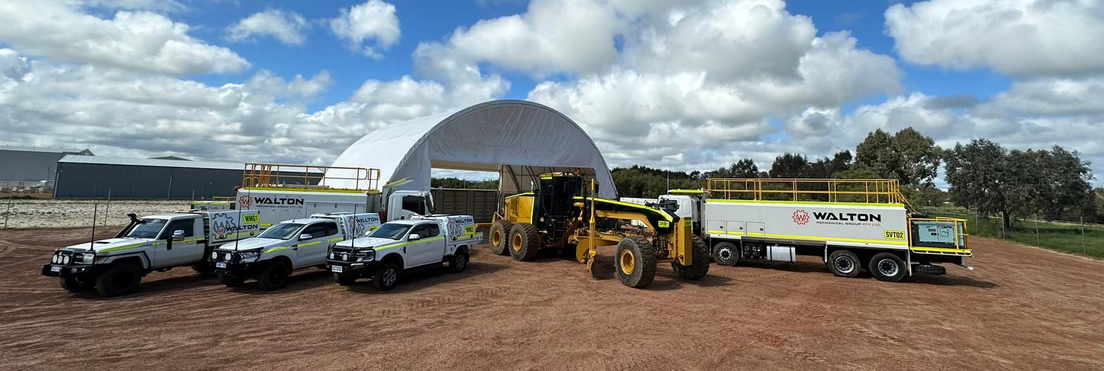 The Walton Mechanical Group fleet lined up: service utes, a CAT grader and a fitted service truck on a WA yard
